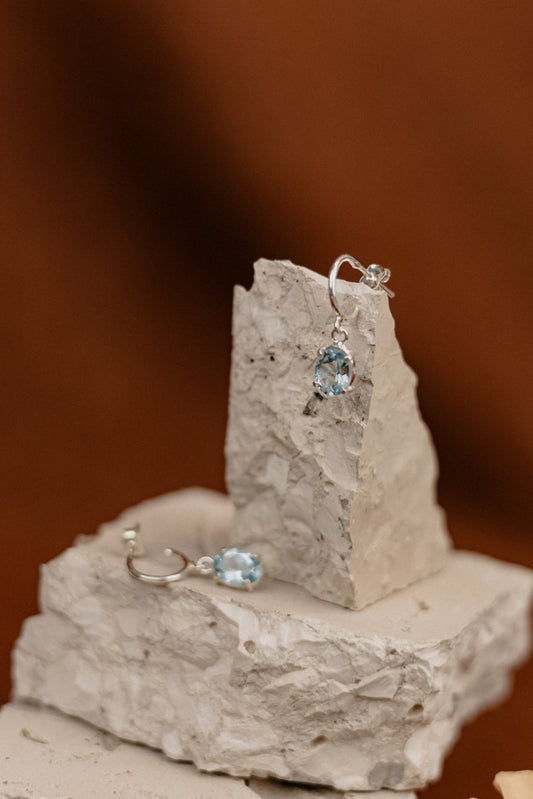 Blue Topaz Oval Drop Earrings on Silver Hoops
